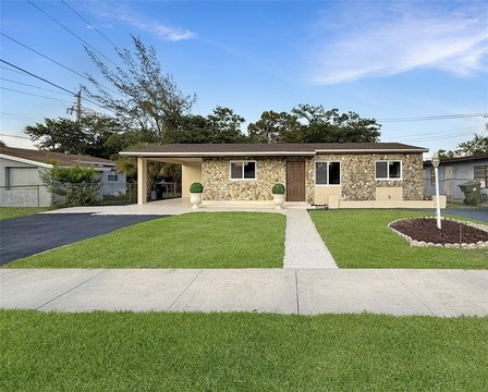 Single-story stone-front house with driveway and lawn in Fort Lauderdale managed by Threshold Management