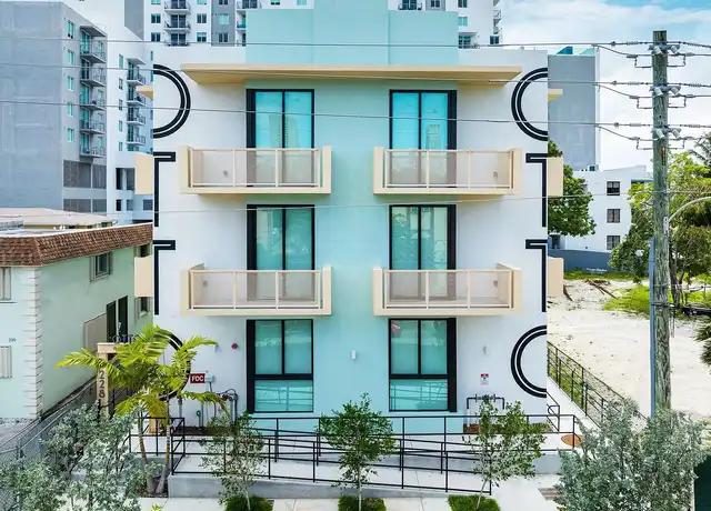 Modern pastel apartment building facade in Brickell Miami – Threshold Property Management