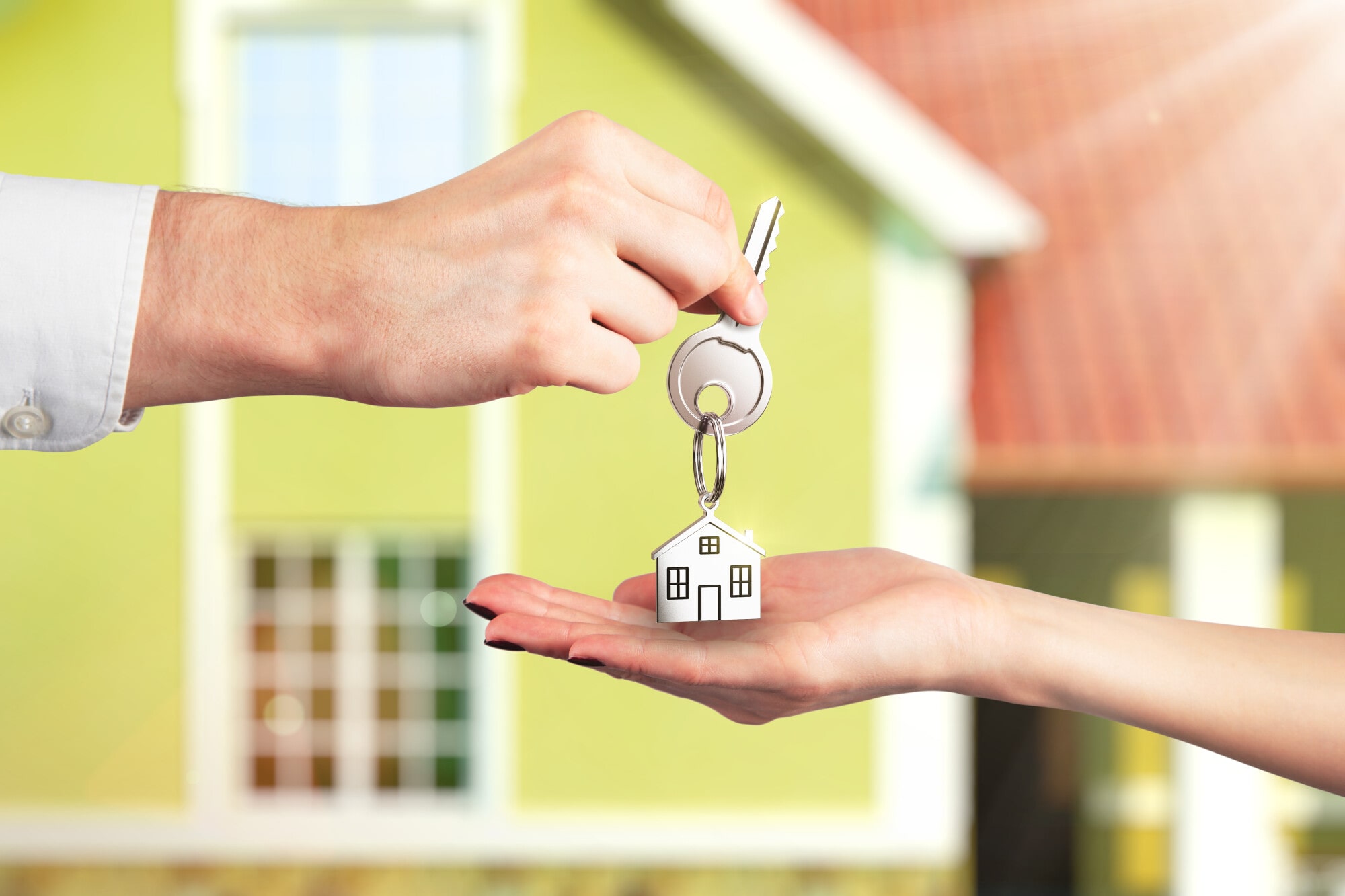 Real estate agent handing over house keys – tenant placement concept for Threshold Property Management