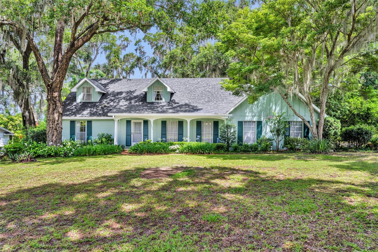 Charming single-family home with mature trees and southern-style porch