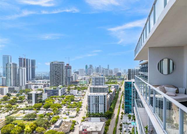 High-rise balcony view overlooking downtown Miami skyline